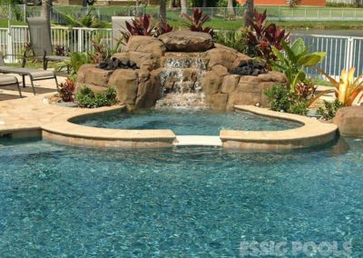 rock features surrounding a spa attached to a swimming pool