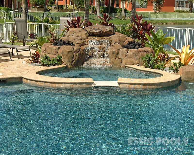 rock features surrounding a spa attached to a swimming pool